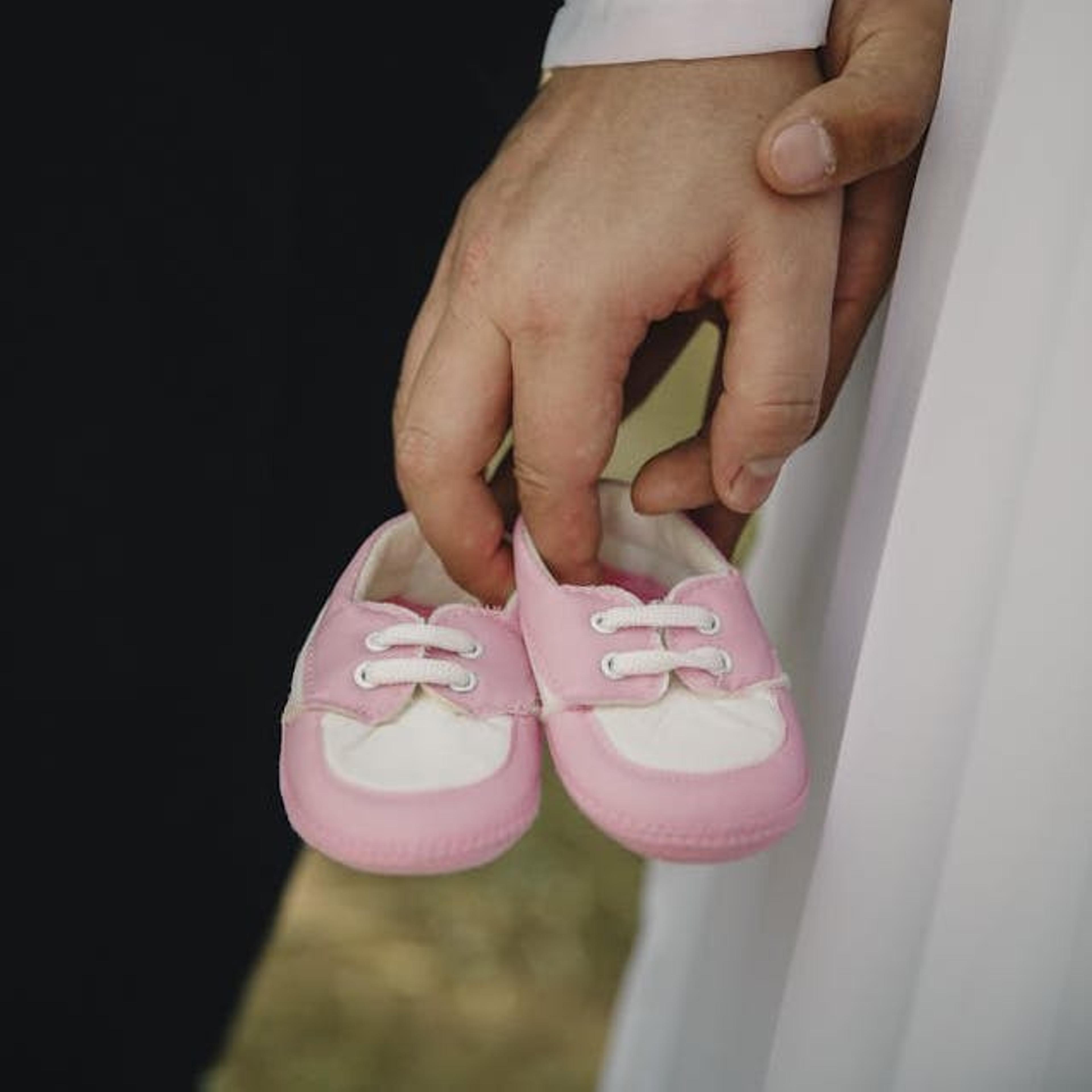 couple with tinu baby shoes